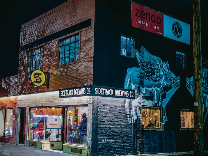 A coffee shop lit up at night.